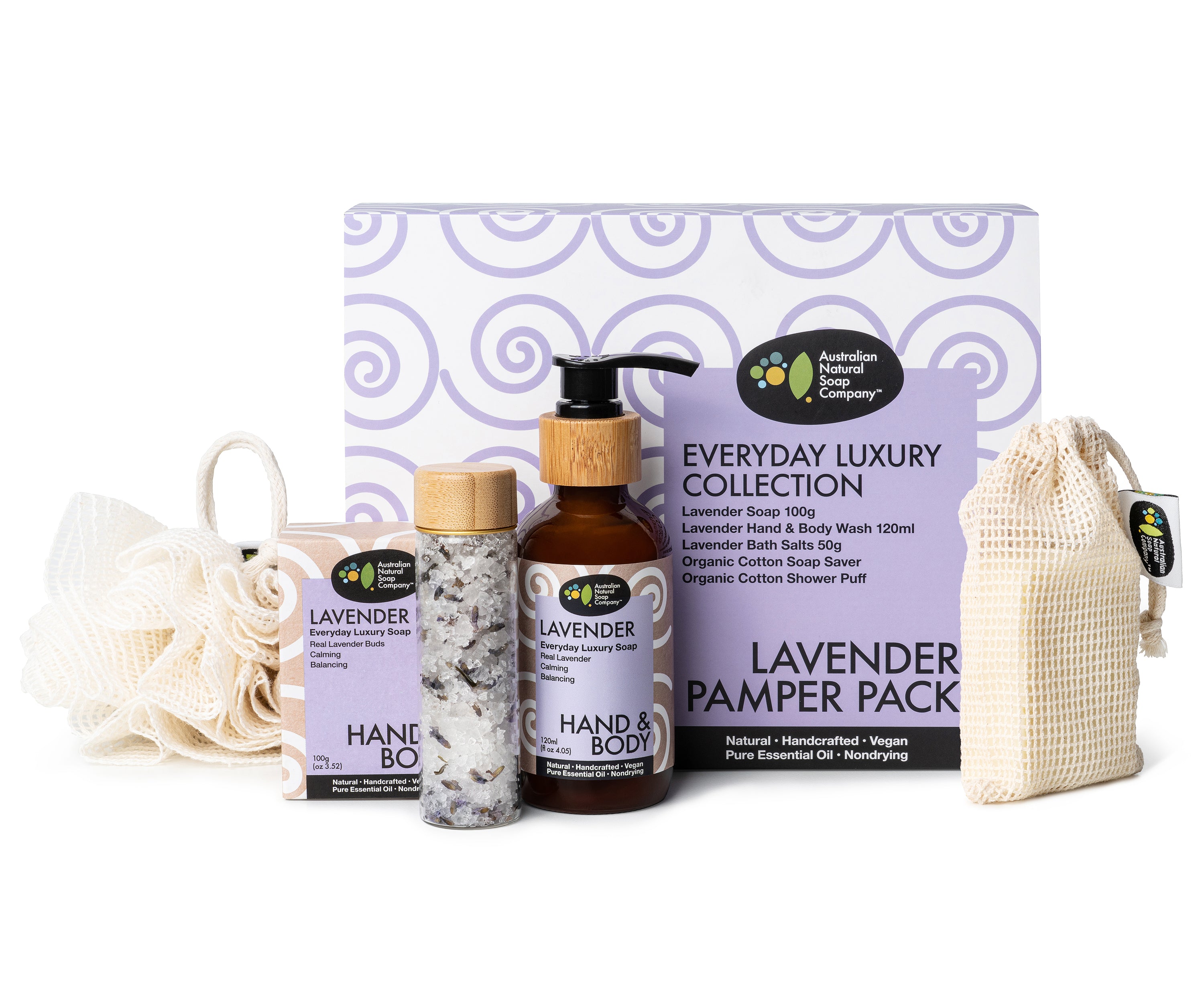 Image of a lavender pamper gift box showcasing its contents. The gift box includes a cotton shower puff, a cotton soap saver bag, a glass bottle with a pump top surrounded by a wooden accent, a glass vial with a wooden top containing bath salts, and a box containing a soap bar. All labels on the items are in a soothing purple color, indicating the lavender theme of the pamper pack.