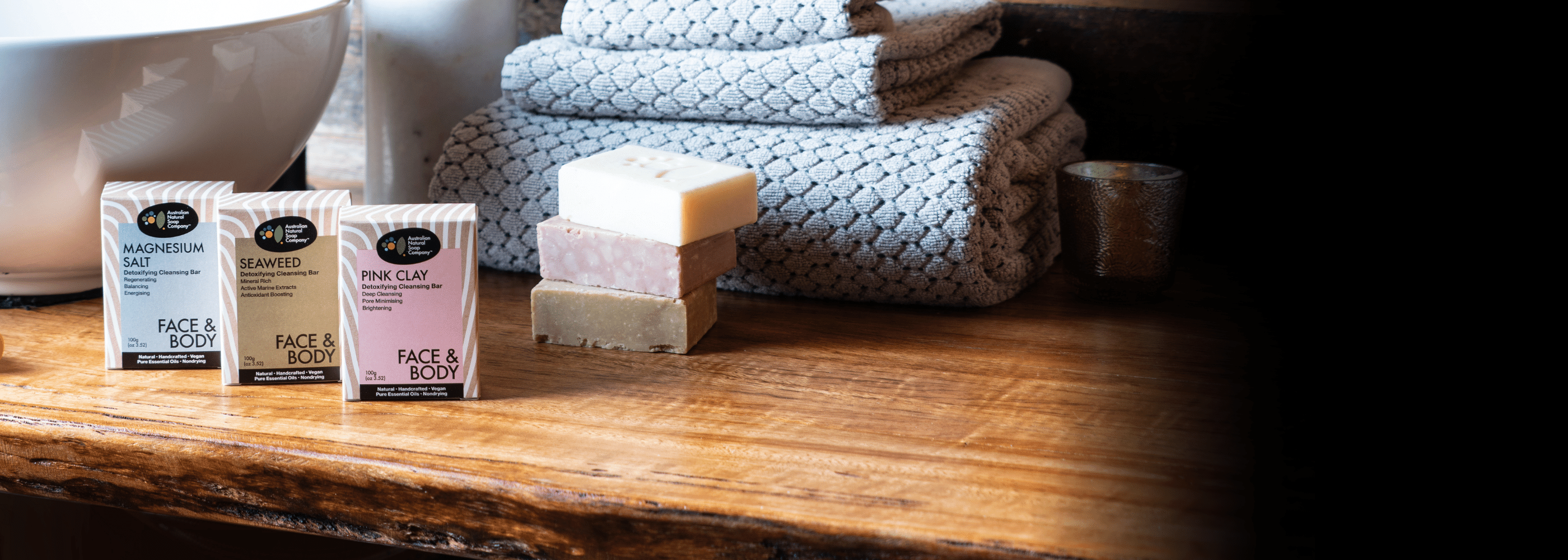Three skin detox soap bars on a wooden bench
