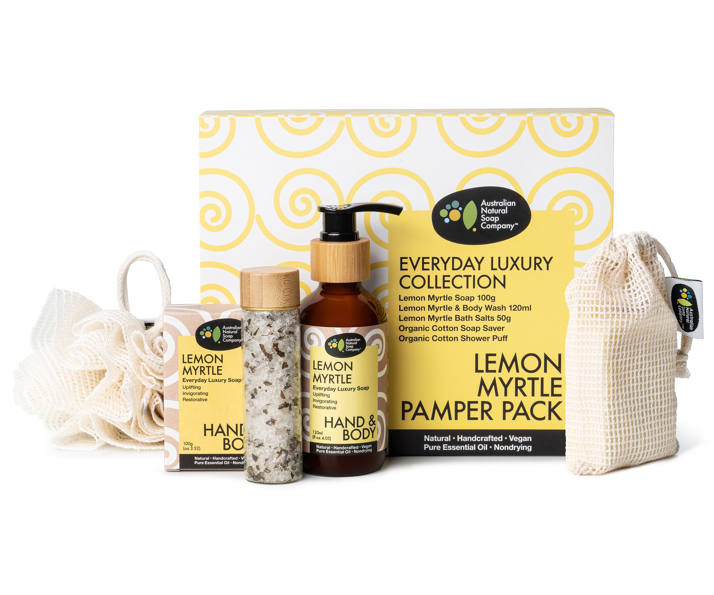 Image of a lemon Myrtle pamper gift box showcasing its contents. The gift box includes a cotton shower puff, a cotton soap saver bag, a glass bottle with a pump top surrounded by a wooden accent, a glass vial with a wooden top containing bath salts, and a box containing a soap bar. All labels on the items are in a upbeat yellow color, indicating the lemon myrtle theme of the pamper pack.